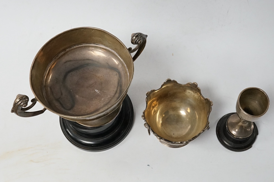A late Victorian silver miniature presentation two handled 'Monteith' bowl, with engraved inscription, Wakely & Wheeler, London, 1900, height 73mm, together with two later silver presentation trophy cups, 12.8oz. Conditi